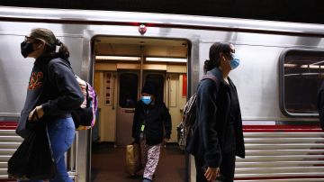 LOS ANGELES, CALIFORNIA - DECEMBER 15: People wear face coverings while departing a Los Angeles Metro Rail train on December 15, 2021 in Los Angeles, California. California residents, regardless of COVID-19 vaccination status, are required to wear face masks in all indoor public settings beginning today in response to rising coronavirus case numbers and the omicron threat. The statewide mandate will be in effect through January 15, 2022. (Photo by Mario Tama/Getty Images)
