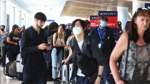 LOS ANGELES, CALIFORNIA - JUNE 30: Travelers gather in the Delta terminal at Los Angeles International Airport (LAX) on June 30, 2022 in Los Angeles, California. Flight cancellations and delays are increasing ahead of the busy Fourth of July travel weekend amid airline staffing shortages. (Photo by Mario Tama/Getty Images)