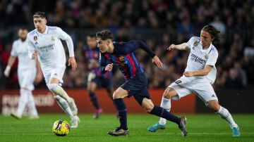 BARCELONA, SPAIN - MARCH 19: Gavi of FC Barcelona battles for possession with Luka Modric of Real Madrid during the LaLiga Santander match between FC Barcelona and Real Madrid CF at Spotify Camp Nou on March 19, 2023 in Barcelona, Spain. (Photo by Alex Caparros/Getty Images)