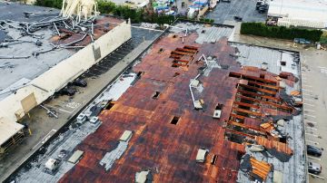MONTEBELLO, CALIFORNIA - MARCH 22: An aerial view of roof damage after a possible rare tornado touched down and ripped up building roofs in a Los Angeles suburb on March 22, 2023 in Montebello, California. Another Pacific storm has been pounding California with heavy rain, high winds, and snow in higher elevatio. (Photo by Mario Tama/Getty Images)