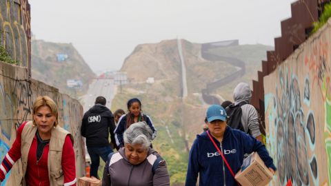 Peridistas de Tijuana y San DIego llevaron alimento a los migrantes en el muro fronterizo.