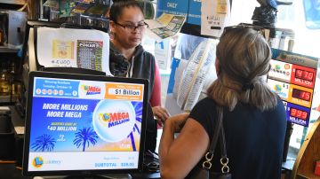 Customers buy Mega Millions tickets hours before the draw of the USD 1 billion jackpot, at the Bluebird Liquor store in Torrance, California on October 19, 2018. (Photo by Mark RALSTON / AFP) (Photo credit should read MARK RALSTON/AFP via Getty Images)