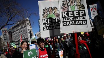 OAKLAND, CALIFORNIA - FEBRUARY 21: Oakland Unified School District students, teachers and parent carry signs as they march to the Oakland Unified School District headquarters on February 21, 2019 in Oakland, California. Nearly 3,000 teachers in Oakland have gone on strike and are demanding a 12 percent retroactive raise. (Photo by Justin Sullivan/Getty Images)