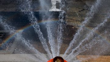 PHILADELPHIA, PA - July 20: A rainbow forms through a spraying fire hydrant on July 20, 2019 in Philadelphia, PA. With heat indexes reaching 105 to 115 degrees today and tomorrow, an excessive heating warning has been designated for this weekend in multiple regions of the U.S. (Photo by Mark Makela/Getty Images)