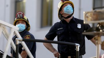 GLENDALE, CALIFORNIA - APRIL 16: Firefighters wear face masks as they prepare to pay tribute to healthcare workers during a shift change at Glendale Memorial Hospital amidst the coronavirus pandemic on April 16, 2020 in Glendale, California. Frontline healthcare workers are receiving tributes from police and fire departments across the country as the spread of COVID-19 continues. (Photo by Mario Tama/Getty Images)