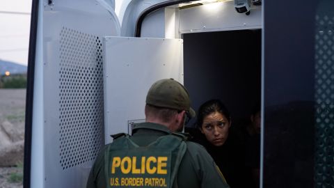 TOPSHOT - A woman who was apprehended crossing the US-Mexico border, speaks to a United States Border Patrol agent from the back of a transport van in Sunland Park, New Mexico on July 22, 2021. - Many advocates from national organizations urge President Biden to end Title 42 expulsions, a public health order issued in March 2020 by the Centers for Disease Control and Prevention to prevent the cross-border spread of Covid-19 resulting of hundreds of thousands of migrants expelled within hours of detention and therefore deny the opportunity to state their case for staying in the country. (Photo by PAUL RATJE / AFP) (Photo by PAUL RATJE/AFP via Getty Images)