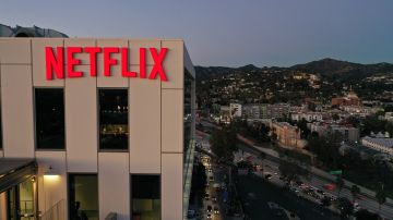 The Netflix logo is seen on top of their office building in Hollywood, California, January 20, 2022. - Netflix on Thursday reported cooling subscriber growth as fierce competition and the pandemic weigh heavy despite hits like "Squid Game" and "Money Heist." The streaming service ended the year with 221.8 million subscribers, just below target, after booming during coronavirus lockdowns that kept people at home and on the platform. (Photo by Robyn Beck / AFP) (Photo by ROBYN BECK/AFP via Getty Images)