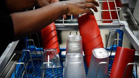 An employee removes reusable dishes and containers from a dishwasher at a McDonald's restaurant in Levallois-Perret, near Paris, on December 20, 2022. - From January 1, 2023, within the framework of the anti-waste law, fast food restaurants must use reusable dishes for on-site orders. (Photo by JULIEN DE ROSA / AFP) (Photo by JULIEN DE ROSA/AFP via Getty Images)