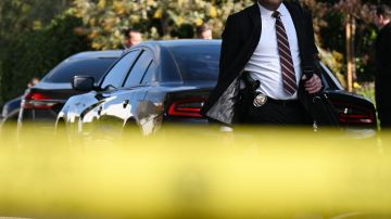A detective walks at the scene of an investigation after an early morning shooting that left three people dead and four wounded in the Beverly Crest neighborhood of Los Angeles, just north of Beverly Hills, on January 28, 2023. - Three people were shot dead January 28 and four others injured at a luxury home near Beverly Hills, at what US police described as a gathering at a short-term rental property. (Photo by Robyn BECK / AFP) (Photo by ROBYN BECK/ AFP/AFP via Getty Images)