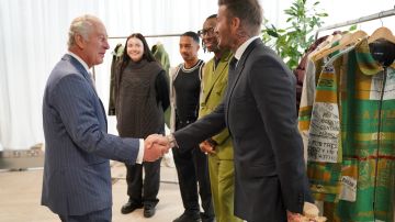 LONDON, ENGLAND - MAY 18: King Charles III shakes hands with David Beckham during a special industry showcase event hosted by the British Fashion Council (BFC) at 180 Studios during BFC Impact Day 2023 on May 18, 2023 in London, England. (Photo by Jonathan Brady-WPA Pool/Getty Images)