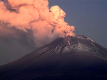 Ash and smoke billow from the Popocatepetl volcano as seen from the Santiago Xalitzintla community, state of Puebla, Mexico, on May 25, 2023. The Popocatepetl volcano, located around 70 kilometres (about 45 miles) from Mexico City, spewed more gas and ash into the sky on May 23 as authorities maintained their warning level at one step below red alert. The government is monitoring Popocatepetl "day and night," President Andres Manuel Lopez Obrador said after the volcano put on another fiery show overnight. (Photo by CLAUDIO CRUZ / AFP) (Photo by CLAUDIO CRUZ/AFP via Getty Images)