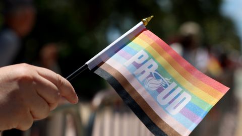 MIAMI BEACH, FLORIDA - APRIL 16: A parade goer holds a flag as she watches as the 15th annual Miami Beach Pride Celebration parade passes by on April 16, 2023 in Miami Beach, Florida. The parade featured a celebration of the LGBTQ+ community with floats, drag performers, and other parade participants. (Photo by Joe Raedle/Getty Images)