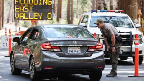 YOSEMITE NATIONAL PARK, CALIFORNIA - APRIL 29: A park ranger speaks to a driver at a checkpoint for a road closed due to flooding in Yosemite Valley, as warming temperatures have increased snowpack runoff, on April 29, 2023 in Yosemite National Park, California. Most of Yosemite Valley is now closed because of the risk of extensive flooding from the melting snowpack amid a heat wave. As of April 1, snowpack in the Tuolumne River basin of Yosemite National Park was 244% of average amid record snowpack levels for some parts of California after years of drought. (Photo by Mario Tama/Getty Images)