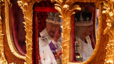 LONDON, ENGLAND - MAY 06: King Charles III and Queen Camilla travelling in the Gold State Coach built in 1760 and used at every Coronation since that of William IV in 1831 go down The Mall flanked by service men and women of the commonwealth during the Coronation of King Charles III and Queen Camilla on May 06, 2023 in London, England. The Coronation of Charles III and his wife, Camilla, as King and Queen of the United Kingdom of Great Britain and Northern Ireland, and the other Commonwealth realms takes place at Westminster Abbey today. Charles acceded to the throne on 8 September 2022, upon the death of his mother, Elizabeth II. (Photo by Richard Heathcote/Getty Images)