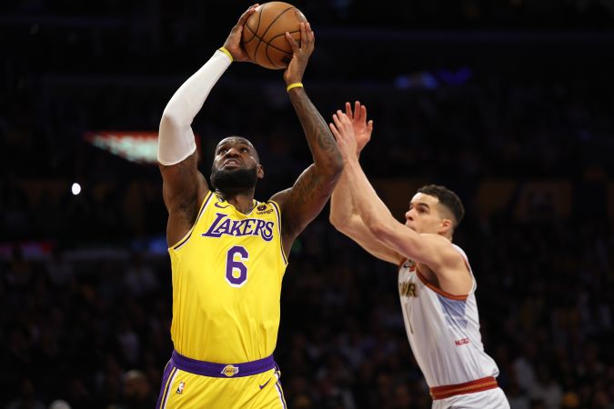 LOS ANGELES, CALIFORNIA - MAY 22: LeBron James #6 of the Los Angeles Lakers attempts a dunk in front of Michael Porter Jr. #1 of the Denver Nuggets during the first quarter in game four of the Western Conference Finals at Crypto.com Arena on May 22, 2023 in Los Angeles, California. NOTE TO USER: User expressly acknowledges and agrees that, by downloading and or using this photograph, User is consenting to the terms and conditions of the Getty Images License Agreement. (Photo by Harry How/Getty Images)