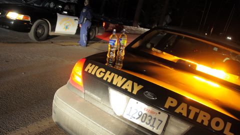 California Highway Patrol officers confer at a roadblock on Highway 38 near Angeles Oaks during a standoff with fugitive ex-cop Christopher Dorner, near San Bernardino, California on February 12, 2013. Nobody has yet been found in a burnt-out US mountain cabin where Dorner was believed to have barricaded himself after a six-day manhunt, a police spokesman said. Media reports that a body had been found in the cabin near Big Bear, east of Los Angeles, and identified as Dorner's were false, said Los Angeles Police Department (LAPD) spokesman Andrew Smith. AFP PHOTO /JOE KLAMAR (Photo credit should read JOE KLAMAR/AFP via Getty Images)