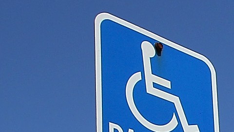 SAUSALITO, CA - JULY 20: A van is parked in a disabled parking spot on July 20, 2011 in Sausalito, California. The California DMV says that is has sent out nearly 60,000 disabled parking placards to dead people since the DMV only checks state death records every two years. The disabled parking placards allow handicapped motorists to park for free and in designated parking spots. (Photo by Justin Sullivan/Getty Images)