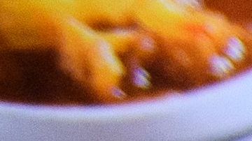 A waiter serves food to customers dining indoors at Langer's Deli in Los Angeles, California on August 7, 2021. - The restaurant announced that proof of vaccination would be required to dine indoors at the restaurant as Covid-19 variant causes surge in the Los Angeles area. (Photo by Patrick T. FALLON / AFP) (Photo by PATRICK T. FALLON/AFP via Getty Images)
