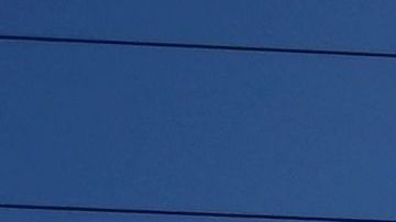 A scorching sun shines above power lines in Rosemead, California on August 31, 2022. - Temperatures as high as 112 degrees Fahrenheit (44 Celsius) were expected in some Los Angeles suburbs as a huge heat dome bakes a swathe of the western United States. The sweltering weather is expected to put huge demands on the already-stretched power grid, especially when people crank up the air conditioners during the broiling hours after work and school. (Photo by Frederic J. BROWN / AFP) (Photo by FREDERIC J. BROWN/AFP via Getty Images)