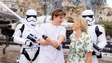 LAKE BUENA VISTA, FL - SEPTEMBER 27: In this handout image provided by Disney, Actors Millie Bobby Brown and Jake Bongiovi joined the Dark Side at Walt Disney World Resort in Lake Buena Vista, Fla. on September 27, 2022. The couple posed with First Order Stormtroopers and Darth Vaders lightsaber at Star Wars: Galaxys Edge at Disneys Hollywood Studios. Bongiovi said he is a big Star Wars fan and Brown said her favorite character is Princess Leia. (Photo by Courtney Kiefer/Disney via Getty Images)