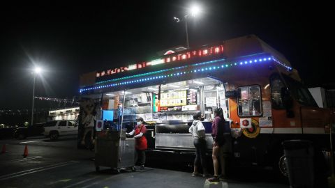 LOS ANGELES, CALIFORNIA - JULY 01: Customers order from a taco truck amid the COVID-19 pandemic on July 1, 2020 in Los Angeles, California. California Governor Gavin Newsom ordered indoor dining restaurants to close again today in Los Angeles County and 18 other counties for at least three weeks amid a surge in new coronavirus cases. Restaurants and food trucks may remain open for takeout and drive-through orders. (Photo by Mario Tama/Getty Images)