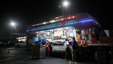 LOS ANGELES, CALIFORNIA - JULY 01: Customers order from a taco truck amid the COVID-19 pandemic on July 1, 2020 in Los Angeles, California. California Governor Gavin Newsom ordered indoor dining restaurants to close again today in Los Angeles County and 18 other counties for at least three weeks amid a surge in new coronavirus cases. Restaurants and food trucks may remain open for takeout and drive-through orders. (Photo by Mario Tama/Getty Images)