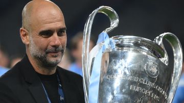 Manchester City's Spanish manager Pep Guardiola celebrates with the European Cup trophy after winning the UEFA Champions League final football match between Inter Milan and Manchester City at the Ataturk Olympic Stadium in Istanbul, on June 10, 2023. (Photo by FRANCK FIFE / AFP) (Photo by FRANCK FIFE/AFP via Getty Images)