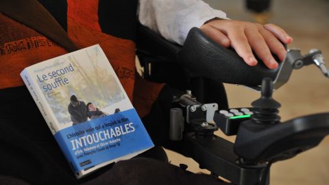 TO GO WITH AFP STORY BY Henri MAMARBACHI - French businessman, writer and tetraplegique survivor of a parasailing accident Philippe Pozzo di Borgo poses with his book at his residence in Essaouira on December 17, 2011. The film "Intouchables" (Untouchable) directed by Olivier Nakache and Eric Toledano was inspired by Di Borgo's book.AFP PHOTO /ABDELHAK SENNA (Photo credit should read ABDELHAK SENNA/AFP via Getty Images)