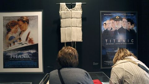 NEW YORK, NY - APRIL 10: A life vest and posters from the 1997 movie "Titanic" hang on display at the opening of the "Titanic at 100: Myth and Memory" exhibition on April 10, 2012 in New York City. The exhibit opened at the Melville Gallery, part of the South Street Seaport Museum, on the 100th anniversary of Titanic's launch on her maiden - and only - voyage. The exhibition features mayday communications from the ship, personal artifacts from survivors, production items from Titanic films and interactive multimedia tours through the ship. The British passenger liner sank in the North Atlantic Ocean, killing more than 1,500 people on April 15,1912 after colliding with an iceberg during her maiden voyage from Southampton, England to New York City. (Photo by John Moore/Getty Images)