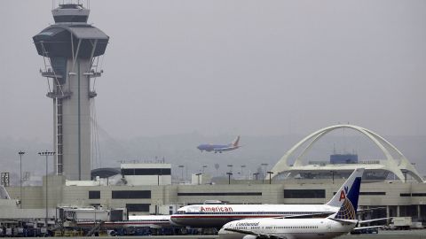 LOS ANGELES, CA - APRIL 10: Jets are seen on the tarmac of Los Angeles Internationl Airport (LAX) in front of the Encoutner restaurant in the U-shaped terminal on April 10, 2004 in Los Angeles, California. Los Angeles International Airport has unveiled a $9 billion plan, backed by LA Mayor Jim Hahn, to attempt to transform itself into the nation's highest-security airport. Changes would require passengers to pass through two screening checkpoints, equipped with the latest explosive-detection technologies, as casino-style security cameras would keep watch over them. Curbside pickup and drop-off of passengers at the terminal would be banned. Travellers would have to be let off a mile from the airport where they would go through security screening then ride a "people mover" train to the airport. (Photo by David McNew/Getty Images)