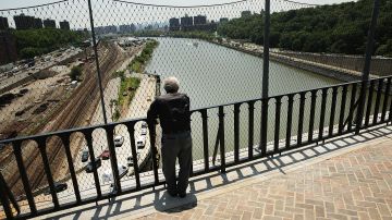 NEW YORK, NY - JUNE 10: A man looks out from the High Bridge, the city's oldest standing bridge, after it recently opened for the first time since it was closed in the early 1970s on June 10, 2015 in New York City. The bridge, which connects Manhattan and the Bronx and spans over the Harlem River, connects 130 acres of parks in the two boroughs. The bridge opened as part of an aqueduct in the mid-1800s to carry water from the Croton River to upper Manhattan which was running short of water at the time. A walkway was added in 1864. Restorations of the 123-foot tall bridge began in 2012 by the Park Department and cost over $60 million. (Photo by Spencer Platt/Getty Images)