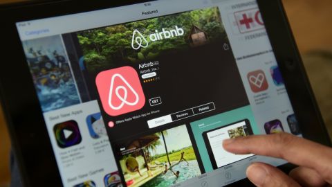 TO GO WITH AFP STORY by ELOI ROUYER A woman browses the site of US home sharing giant Airbnb on a tablet in Berlin on April 28, 2016. - Berlin will from Sunday, May 1, 2016, restrict private property rentals through Airbnb and similar online platforms, threatening hefty fines in a controversial move meant to keep housing affordable for locals. (Photo by John MACDOUGALL / AFP) (Photo credit should read JOHN MACDOUGALL/AFP via Getty Images)