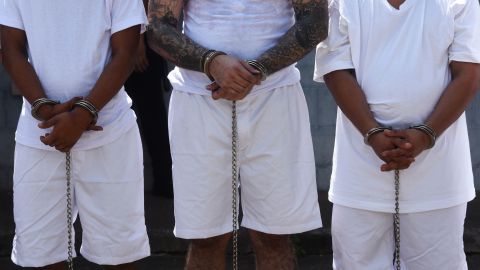 Shackled gang members wait upon arrival at the maximum security prison in Zacatecoluca, 65 km east of San Salvador, on December 1, 2016. Twenty gang members arrested in connection with the murders of policemen and soldiers were transferred on December 1 to Zacatecoluca. The Salvadoran authorities reported that all of them were members of the violent MS-13 gang. / AFP / Marvin RECINOS (Photo credit should read MARVIN RECINOS/AFP via Getty Images)