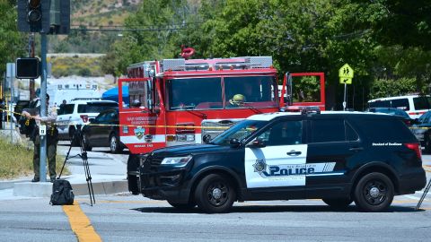 A police vehicle stands at a closed-off street outside the North Park Elementary School in San Bernadino, California on April 10, 2017 after a gunman entered a classroom and killed one woman and one student before turning the gun on himself. (Photo by FREDERIC J. BROWN / AFP) (Photo by FREDERIC J. BROWN/AFP via Getty Images)