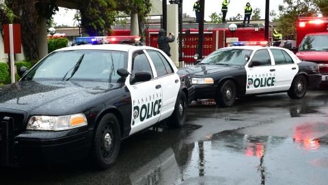 Pasadena police and fire department personnel flash emergency lights and blast their sirens in front of Huntington Hospital in Pasadena, California on April 9, 2020, in a show of appreciation for healthcare workers in the emergency room and throughout the hospital amid the cronavirus pandemic. Effective Friday April 10 all workers and residents in Los Angeles County will be required to wear a mask, bandana or other kind of face covering when at essential businesses. (Photo by Frederic J. BROWN / AFP) (Photo by FREDERIC J. BROWN/AFP via Getty Images)