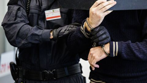 Defendant Wissam R (R) is led in handcuffs into the courtroom of the Higher Regional Court in Dresden, eastern Germany on August 30, 2022 prior to a hearing in the trial over a jewellery heist on the Green Vault (Gruenes Gewoelbe) museum in Dresden's Royal Palace in November 2019. - Six members of a notorious criminal gang stand trial in Germany over the spectacular heist in which 18th-century jewels were snatched from the state museum in Dresden. They are accused of gang robbery and arson after the brazen night raid on The Green Vault museum on November 25, 2019. (Photo by JENS SCHLUETER / POOL / AFP) (Photo by JENS SCHLUETER/POOL/AFP via Getty Images)