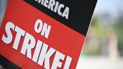 A strike sign is seen on the Hollywood writers picket line outside Universal Studios Hollywood in Los Angeles, California, June 30, 2023. Hollywood's summer of discontent could dramatically escalate this weekend, with actors ready to join writers in a massive "double strike" that would bring nearly all US film and television productions to a halt. The Screen Actors Guild (SAG-AFTRA) is locked in last-minute negotiations with the likes of Netflix and Disney, with the deadline fast approaching at midnight Friday (0700 GMT Saturday). (Photo by Robyn Beck / AFP) (Photo by ROBYN BECK/AFP via Getty Images)