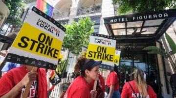 Striking hotel workers walk the picket line outside of Hotel Figueroa in Los Angeles, California, on July 2, 2023. Thousands of hotel workers in Southern California walked off the job on Sunday, in an effort to secure higher pay and improvements in health care and retirement benefits. (Photo by RINGO CHIU / AFP) (Photo by RINGO CHIU/AFP via Getty Images)