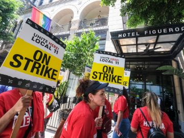 Striking hotel workers walk the picket line outside of Hotel Figueroa in Los Angeles, California, on July 2, 2023. Thousands of hotel workers in Southern California walked off the job on Sunday, in an effort to secure higher pay and improvements in health care and retirement benefits. (Photo by RINGO CHIU / AFP) (Photo by RINGO CHIU/AFP via Getty Images)