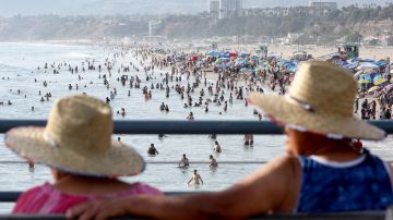 SANTA MONICA, CALIFORNIA - SEPTEMBER 04: People sit on Santa Monica pier amid an intense heat wave in Southern California on September 4, 2022 in Santa Monica, California. The National Weather Service issued an Excessive Heat Warning for most of Southern California through September 7. Climate models almost unanimously predict that heat waves will become more intense and frequent as the planet continues to warm. (Photo by Mario Tama/Getty Images)