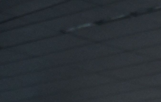 A security guards watches as hotel workers hold placards during the second day on their strike for a better wage in front of the JW Marriot Hotel on July 3, 2023 in Los Angeles, California. Contracts between UNITE HERE Local 11 and 61 hotels expired at midnight on Friday, June 30. (Photo by Frederic J. BROWN / AFP) (Photo by FREDERIC J. BROWN/AFP via Getty Images)