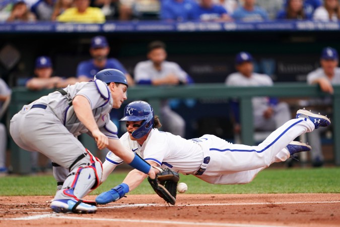 KANSAS CITY, MISSOURI - JULY 01: Bobby Witt Jr. #7 of the Kansas City Royals slides in before the tag by Will Smith #16 of the Los Angeles Dodgers during the first inning at Kauffman Stadium on July 01, 2023 in Kansas City, Missouri. (Photo by Kyle Rivas/Getty Images)