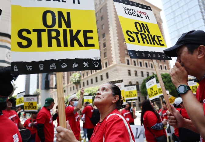 LOS ANGELES, CALIFORNIA - JULY 02: Hotel workers with Unite Here Local 11 picket outside the InterContinental hotel on the first day of a strike by union members on July 2, 2023 in Los Angeles, California. The union represents nearly 15,000 workers from 65 major hotels in Los Angeles and Orange Counties who are calling for higher pay and increased benefits. Affected hotels are currently remaining open with management and nonunion staff attempting to fill in during the strike ahead of the 4th of July holiday. (Photo by Mario Tama/Getty Images)