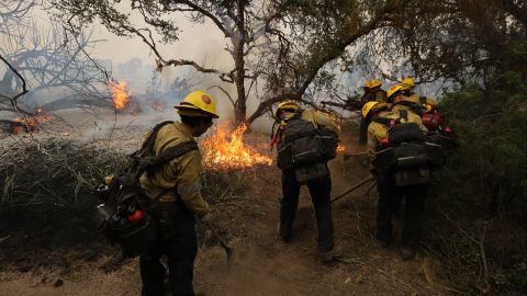 Firefighters clear the area to control the Gavilan Fire, which has already burned more than 250 acres in Perris, Riverside County, California, on July 15, 2023. Brutally high temperatures threatened tens of millions of Americans July 15, as numerous cities braced to break records under a relentless heat dome that has baked parts of the country all week. The National Weather Service warned of an "extremely hot and dangerous weekend," with daytime highs reaching up to 116 Fahrenheit (47 degres celsius). (Photo by DAVID SWANSON / AFP) (Photo by DAVID SWANSON/AFP via Getty Images)