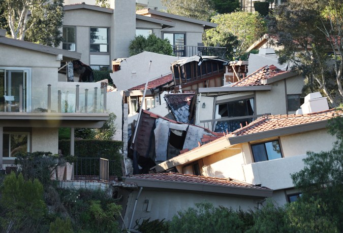ROLLING HILLS ESTATES, CALIFORNIA - JULY 11: A view of upscale homes (R) destroyed by a landslide on Palos Verdes Peninsula on July 11, 2023 in Rolling Hills Estates, California. The still unexplained landslide destroyed 12 homes over the weekend and has sent ten of the homes slowly sliding toward a canyon below, forcing the City Council to declare a local state of emergency. (Photo by Mario Tama/Getty Images)