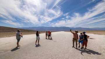FURNACE CREEK, CALIFORNIA - JULY 16: People walk on the salt flat at Badwater, the lowest point in North America at 282 ft (86 m) below sea level, as the temperature rises well into the upper 120 F degrees on a day that could set a new world heat record in Death Valley National Park on July 16, 2023 near Furnace Creek, California. Weather forecasts for tomorrow call for a high temperature of 129 degrees Fahrenheit and possibly as high as 131. Previously, the highest temperature reliably recorded on Earth was 129.2F (54C) in Death Valley in 2013. A century earlier, a high temperature in Death Valley reportedly reached 134F but many modern weather experts have rejected that claim along with other high summer temperatures reported in the region that year. (Photo by David McNew/Getty Images)