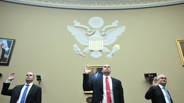(L-R) Ryan Graves, Executive Director of Americans for Safe Aerospace, David Grusch, former National Reconnaissance Officer Representative on the Unidentified Anomalous Phenomena Task Force, and Retired Commander David Fravor, former Commanding Officer in the US Navy, are sworn in to testify during a House Subcommittee on National Security, the Border, and Foreign Affairs hearing titled "Unidentified Anomalous Phenomena: Implications on National Security Public Safety and Government Transparency," on Capitol Hill in Washington, DC, on July 26, 2023. (Photo by Brendan SMIALOWSKI / AFP) (Photo by BRENDAN SMIALOWSKI/AFP via Getty Images)