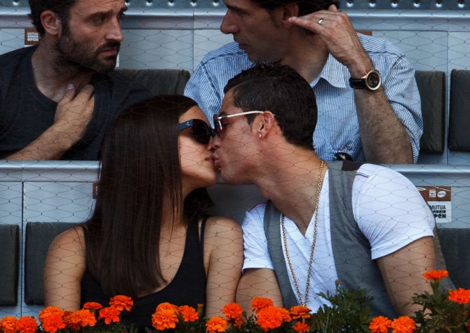 Cristiano Ronaldo (R) besa a su novia Irina Shayk durante el partido entre Rafael Nadal y David Ferrer de España el día siete del torneo de tenis Mutua Madrid Open en la Caja Mágica el 10 de mayo de 2013 en Madrid, España. Foto: Jasper Juinen/Getty Images.