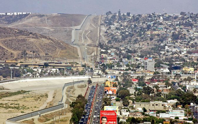 TO GO WITH AFP STORY "Tijuana: A City Under the Shadow of a Double Wall" General view of the border, and wall, that separates Tijuana, in the Mexican state of Baja California, from the United States, 04 August 2007. Fourteen years ago, the United States constructed a wall and fence of nearly 22,5 km in length, between Tijuana in Mexico, and San Diego in the US, as part of Operation Guardian - aim at stopping illegal migration. AFP PHOTO/Luis ACOSTA MORE PHOTOGRAPHS ARE AVAILABLE IN IMAGE FORUM (Photo credit should read LUIS ACOSTA/AFP via Getty Images)