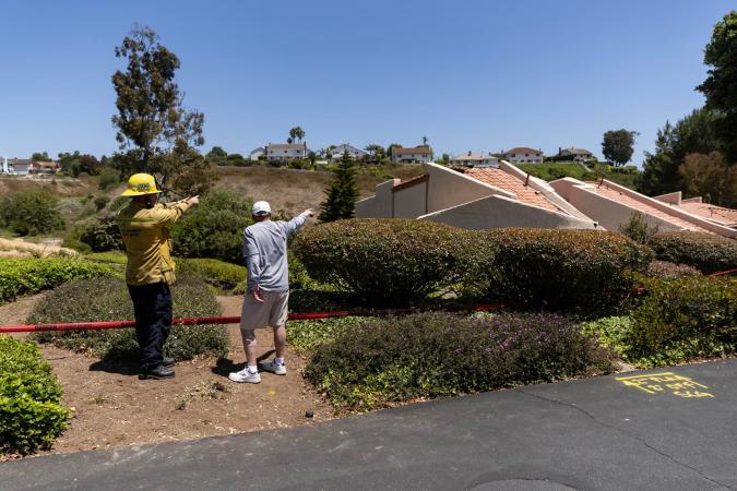 Los Angeles (United States), 09/07/2023.- Neighbors and firefighters point at a collapsed house in Rolling Hills Estates in Los Angeles, California, USA, 09 July 2023. A large landslide in Rolling Hills Estates this weekend forced 12 houses next to a canyon to be evacuated. (Incendio, Estados Unidos) EFE/EPA/ETIENNE LAURENT